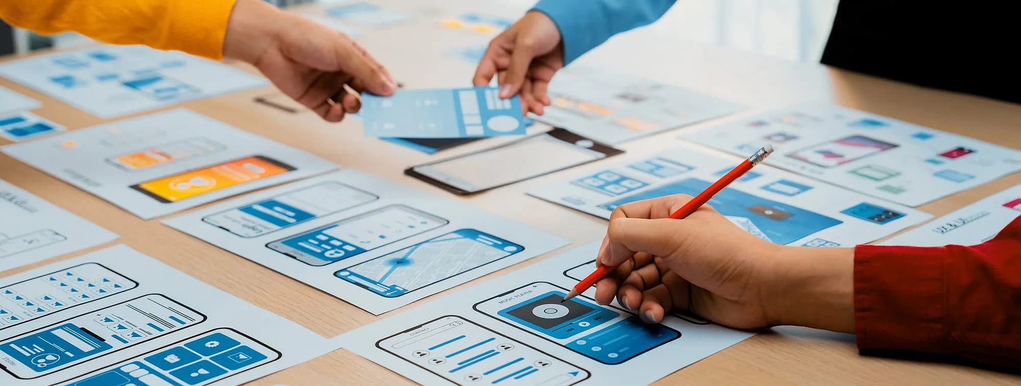 Cross-functional team reviewing product wireframes together around one table