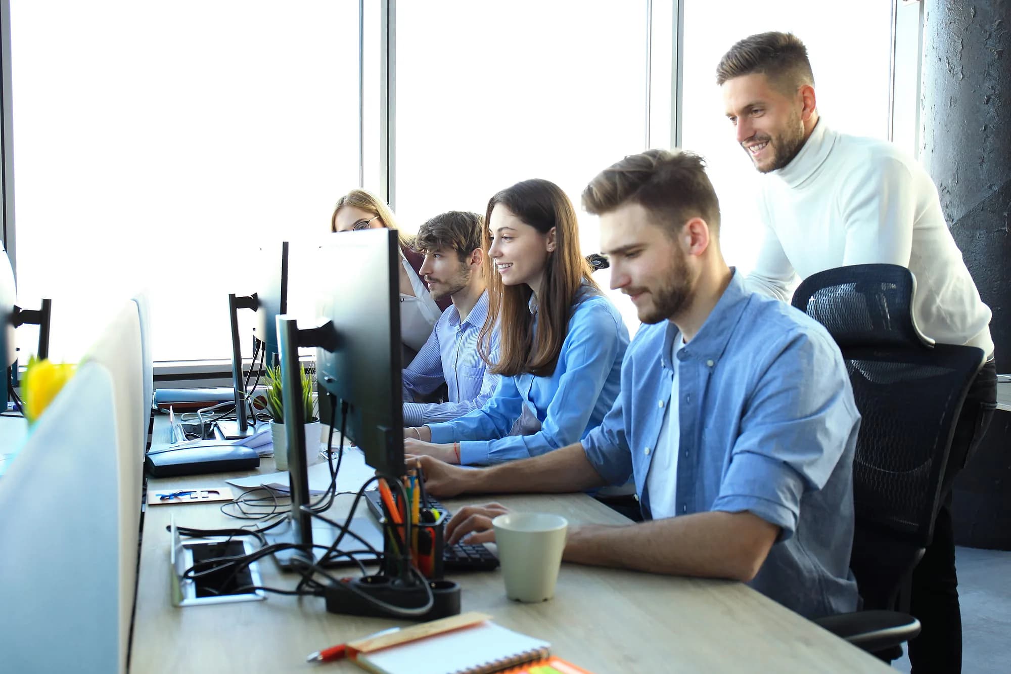 Merilsoft engineers reviewing work together at a shared desk