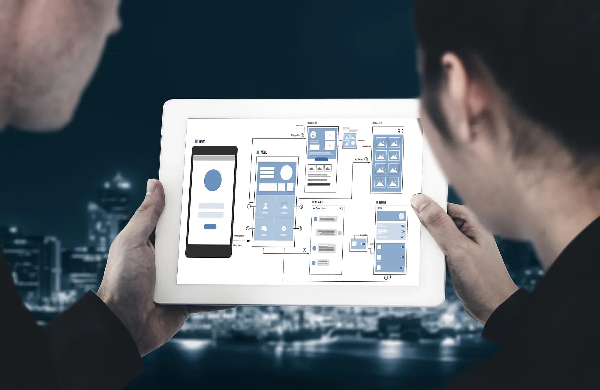 Editor and designer reviewing page layouts on a tablet